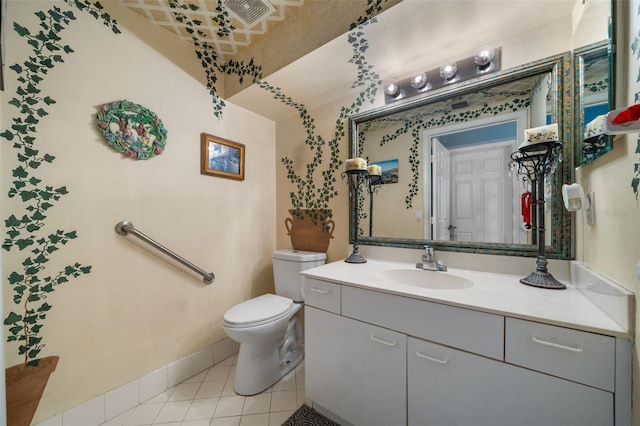 bathroom with tile patterned flooring, toilet, vanity, and baseboards