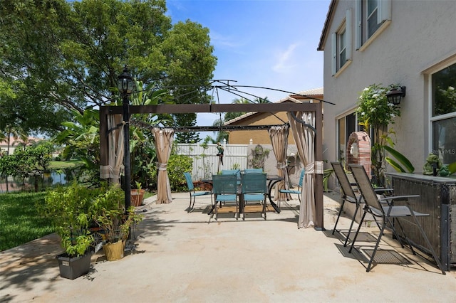 view of patio with outdoor dining space, fence, and a pergola