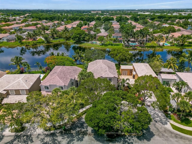 drone / aerial view featuring a residential view and a water view