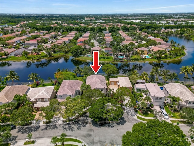 drone / aerial view with a residential view and a water view