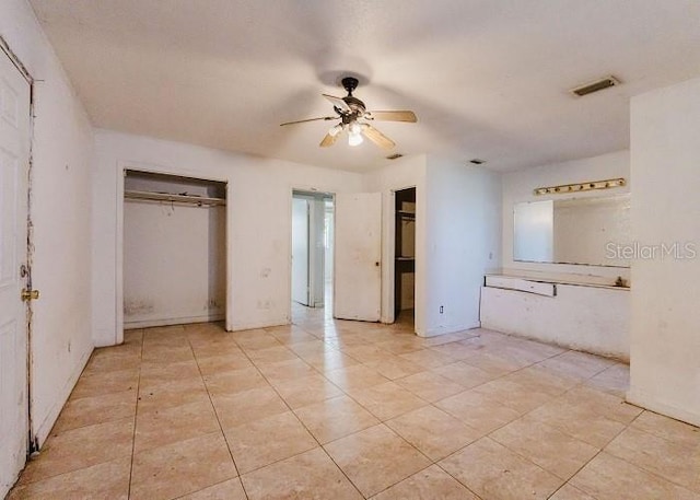 unfurnished bedroom with a closet and ceiling fan