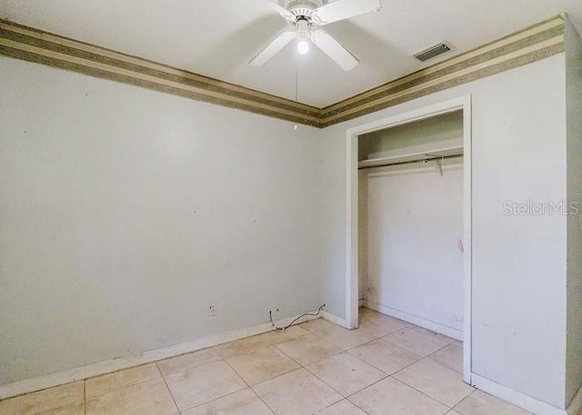 unfurnished bedroom with a closet, ceiling fan, and light tile patterned flooring