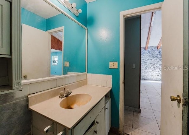 bathroom featuring tile patterned floors, vanity, and a healthy amount of sunlight