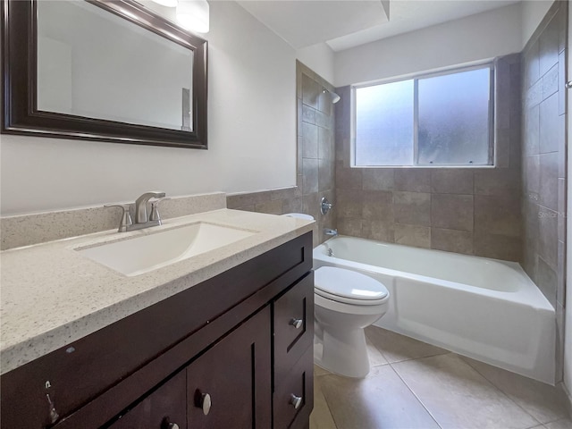 full bathroom featuring toilet, tiled shower / bath, tile patterned floors, and vanity