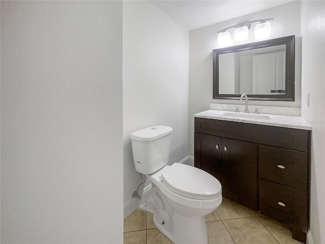 bathroom with vanity, toilet, and tile patterned floors