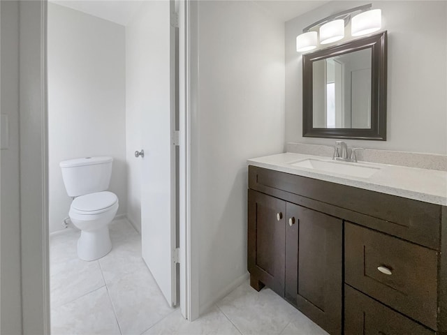 bathroom featuring vanity, toilet, and tile patterned floors