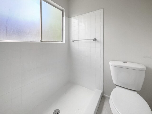 bathroom with toilet and walk in shower