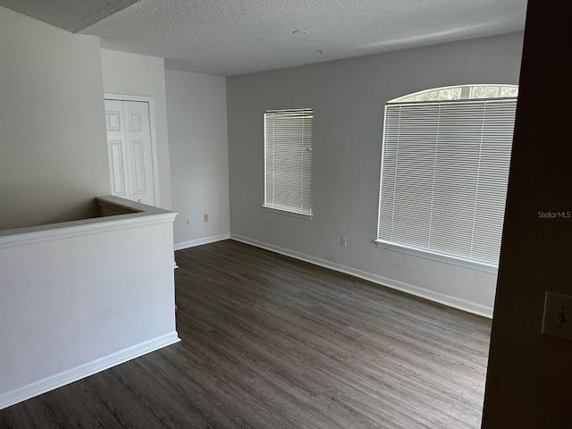 empty room featuring a textured ceiling and hardwood / wood-style flooring