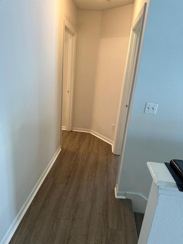 corridor with dark wood-type flooring