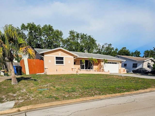 ranch-style home with a front yard and a garage