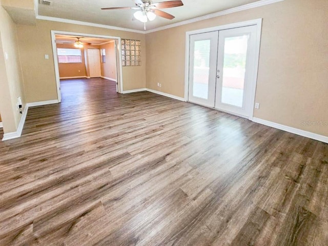 spare room with hardwood / wood-style flooring, french doors, ceiling fan, and crown molding