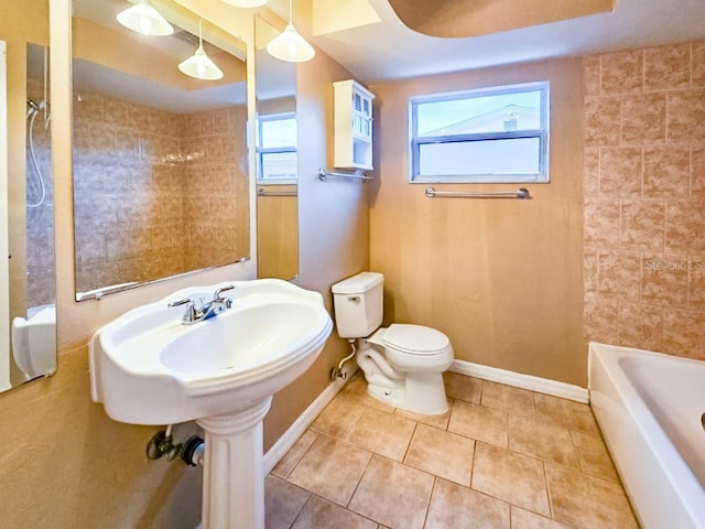 bathroom featuring toilet, tile patterned floors, and shower / bathing tub combination