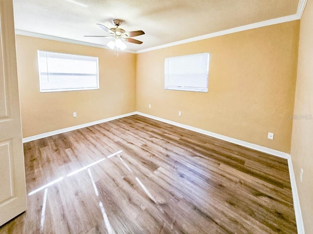 unfurnished room with ceiling fan, crown molding, and wood-type flooring