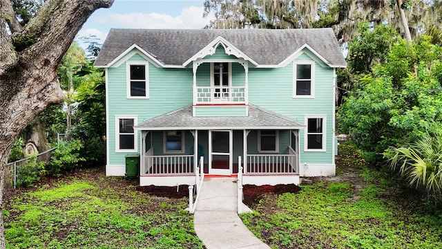 view of front facade featuring a balcony and a sunroom