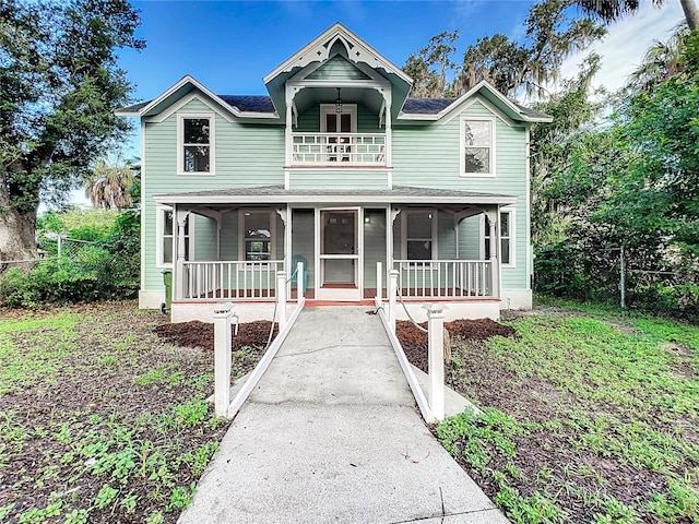 view of front of home with covered porch and a balcony