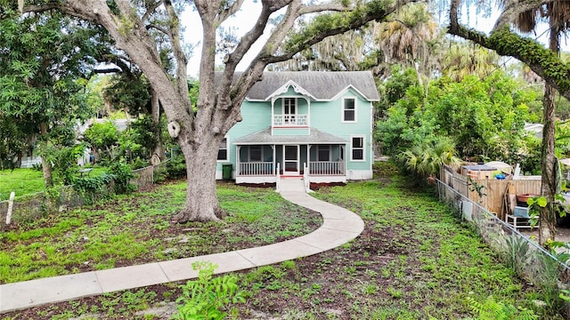 view of front of property with a sunroom and a front lawn