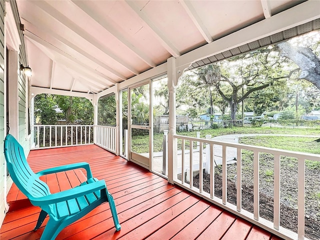 sunroom with lofted ceiling with beams