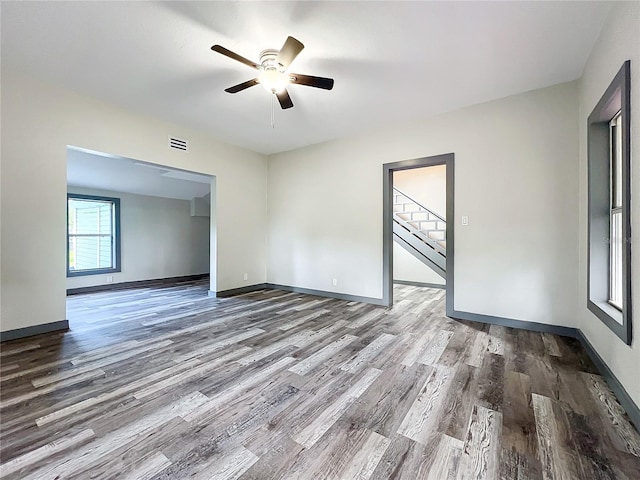 empty room featuring wood-type flooring and ceiling fan