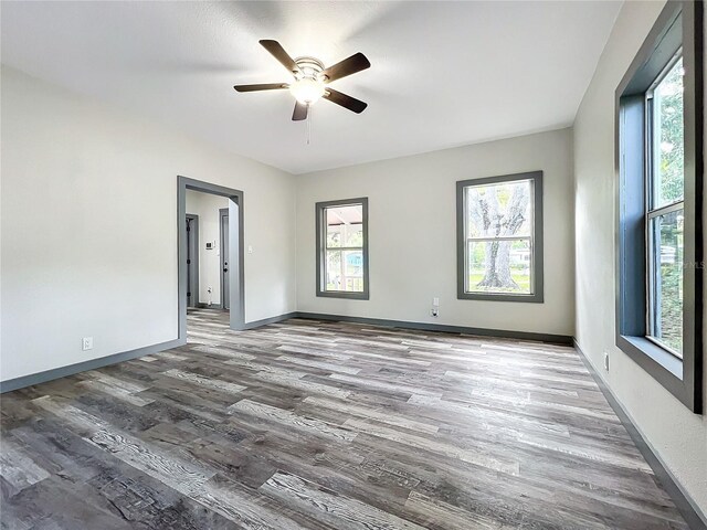 empty room with hardwood / wood-style flooring and ceiling fan