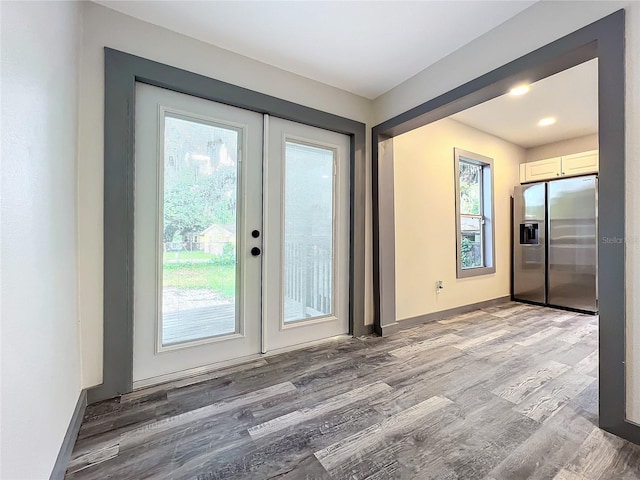 doorway to outside with light hardwood / wood-style flooring and french doors