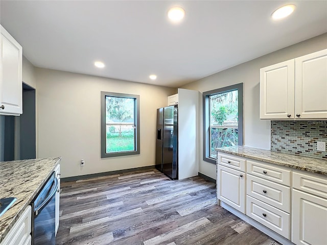 kitchen featuring white cabinetry, stainless steel refrigerator with ice dispenser, decorative backsplash, and dark hardwood / wood-style floors