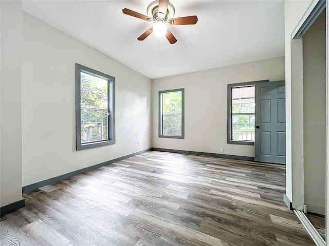 empty room featuring hardwood / wood-style flooring and ceiling fan