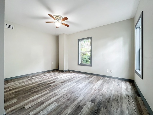 spare room with hardwood / wood-style flooring and ceiling fan