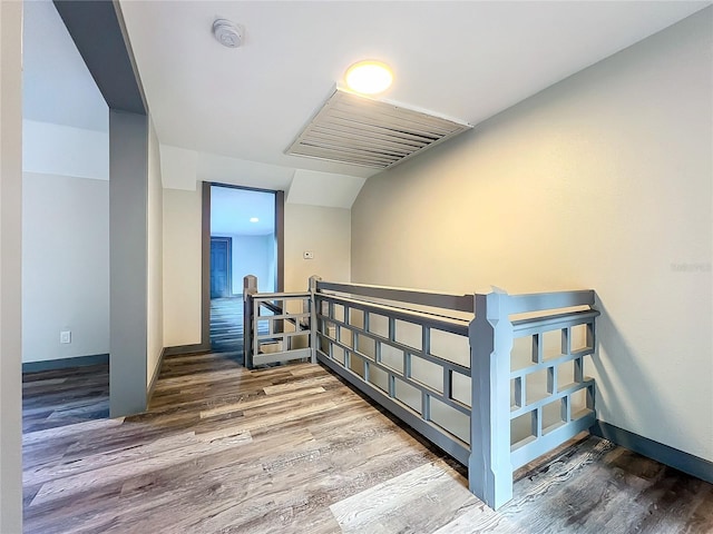 stairs featuring hardwood / wood-style floors