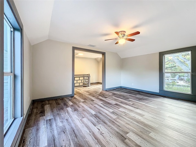 unfurnished bedroom with ceiling fan, hardwood / wood-style flooring, and vaulted ceiling