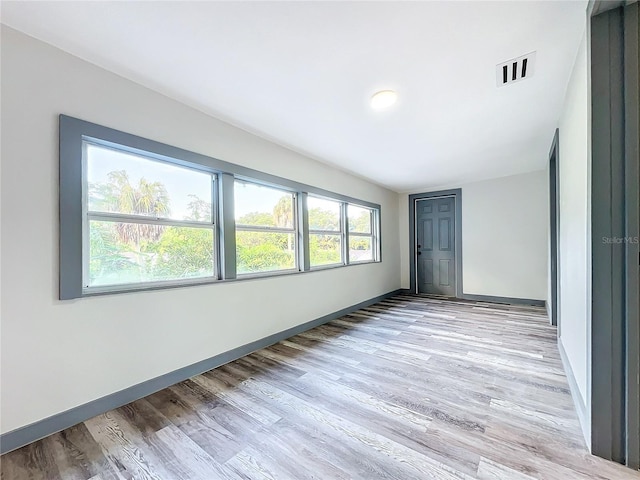 unfurnished room with light wood-type flooring