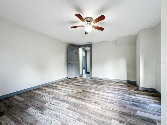 unfurnished room with ceiling fan and hardwood / wood-style floors