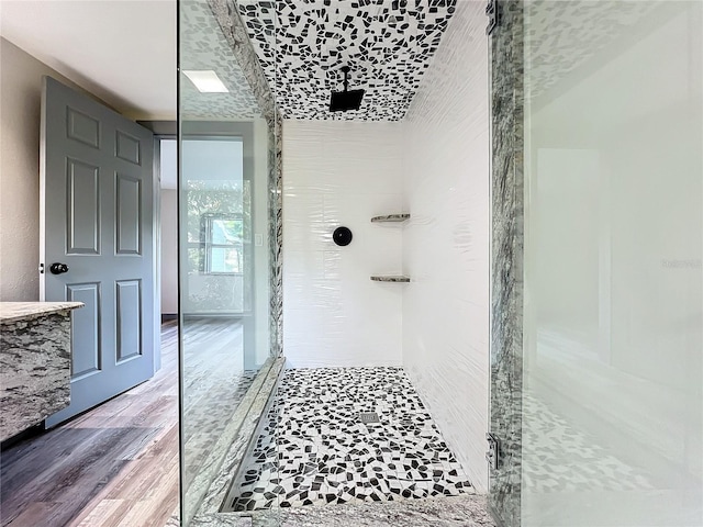 bathroom featuring wood-type flooring and a shower