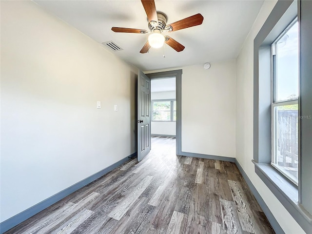 spare room with hardwood / wood-style flooring and ceiling fan