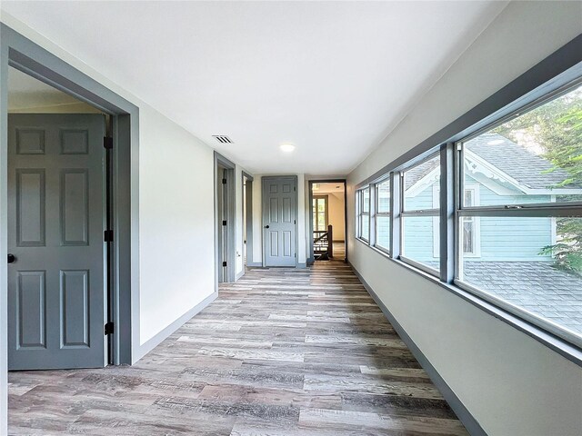 corridor with wood-type flooring