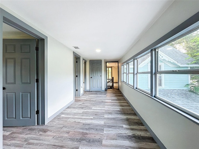 hall with hardwood / wood-style flooring