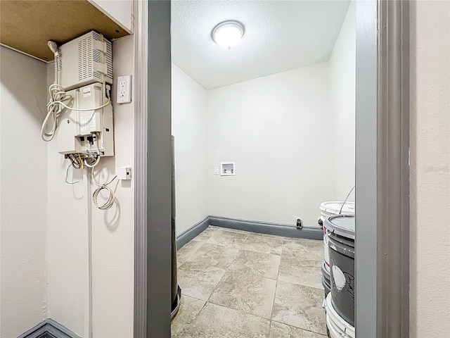 interior space with hookup for a washing machine and a textured ceiling