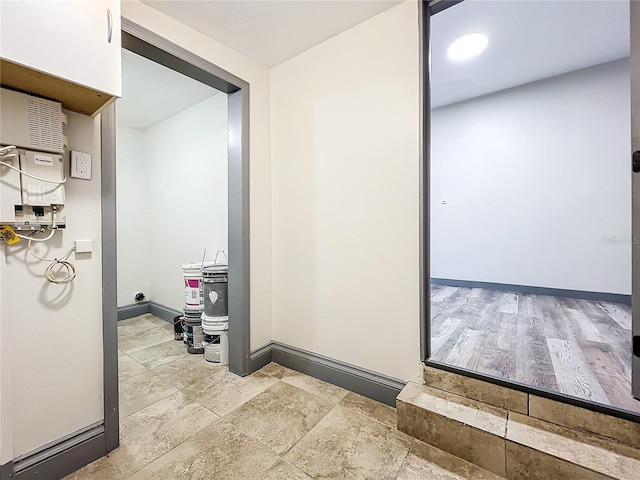 corridor with light hardwood / wood-style floors