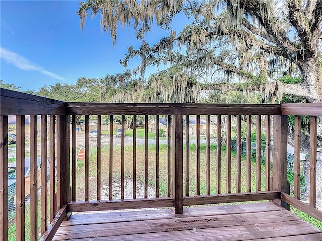 wooden deck with a lawn