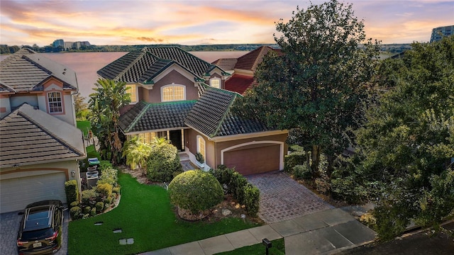 view of front of property with a yard and a garage