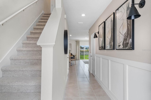 stairway with light tile patterned flooring