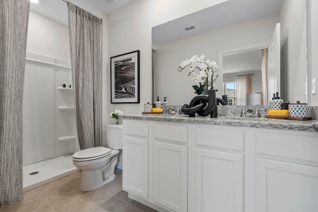 bathroom with a shower with shower curtain, vanity, tile patterned flooring, and toilet