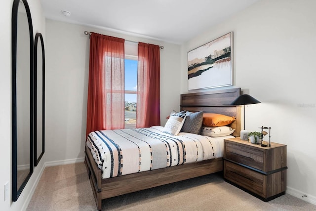 bedroom featuring light colored carpet