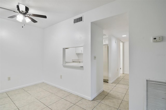 empty room featuring light tile patterned floors and ceiling fan