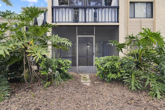 rear view of house featuring a sunroom