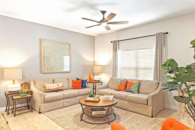 living room featuring light tile patterned floors, a textured ceiling, and ceiling fan