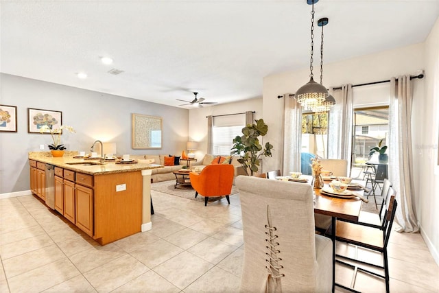 dining room with sink, light tile patterned floors, and ceiling fan