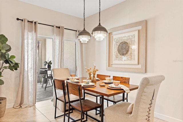 dining space with a chandelier and light tile patterned floors