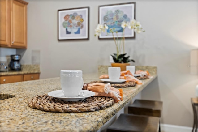 kitchen with light stone countertops and a kitchen breakfast bar