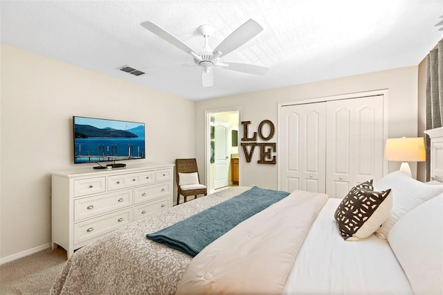 carpeted bedroom with ceiling fan and a closet