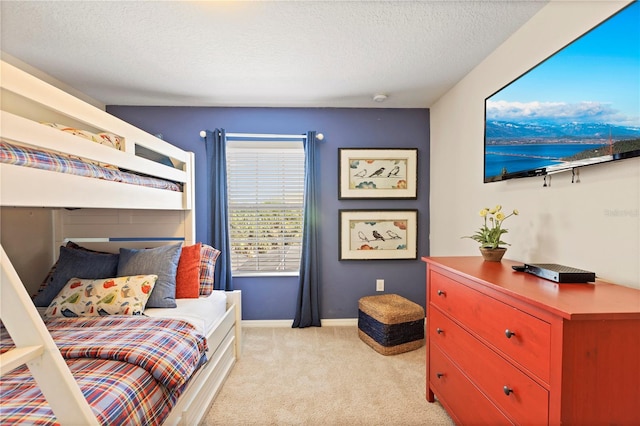 bedroom with light carpet and a textured ceiling